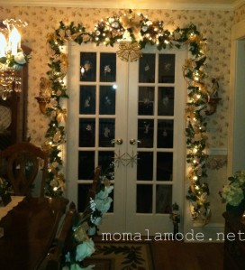 Dining Room French Doors adorned in greens, gold and white lights